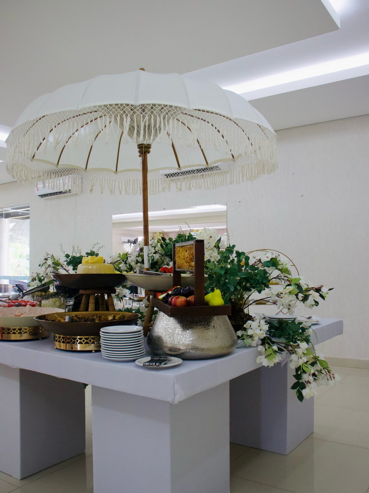 Mesa completa do buffet Dengo Doce decorada com flores